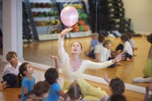 a teacher of ballet pushing a balloon