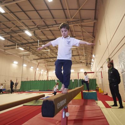 child walking across a beam