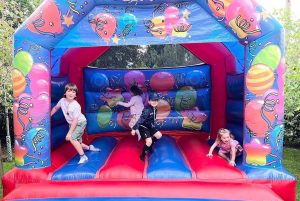 children bouncing around in the inflatable castle