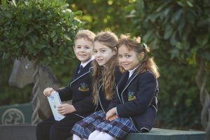 3 students in the garden area of the school