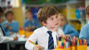 student with a felt tip in his hand looking up